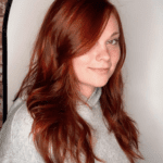 Woman with long, wavy red hair.